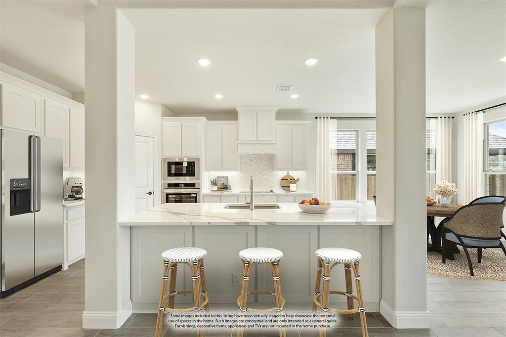 717 Seahawk Street Joshua, TX 76058 - Photo 12 of 40 a kitchen with kitchen island granite countertop a sink and cabinets