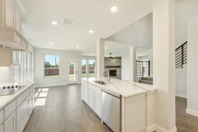 a open kitchen with a sink stove and cabinets