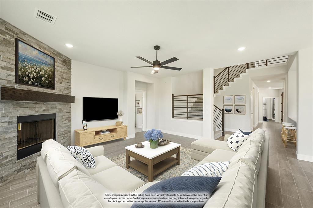 717 Seahawk Street Joshua, TX 76058 - Photo 18 of 40 a living room with furniture a fireplace and a flat screen tv