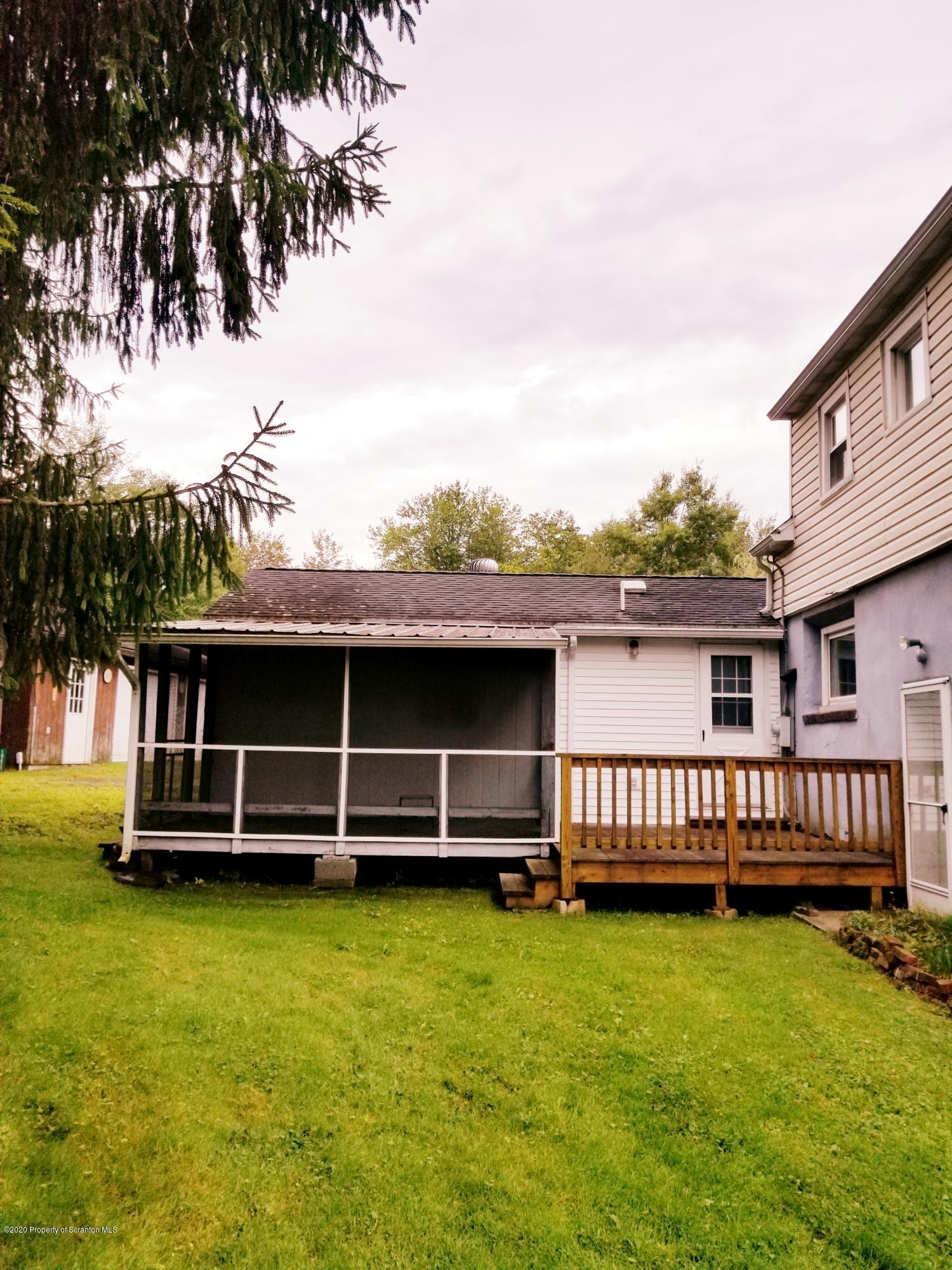 1265 Bendix Road Montrose, PA 18801 - Photo 3 of 20 a view of a house with a wooden deck