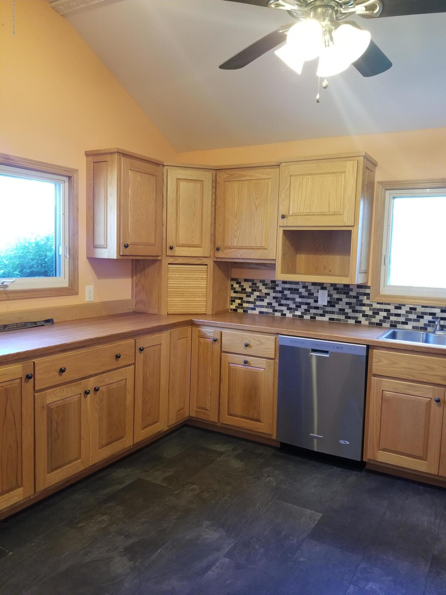 1265 Bendix Road Montrose, PA 18801 - Photo 6 of 20 a kitchen with granite countertop white cabinets and white appliances