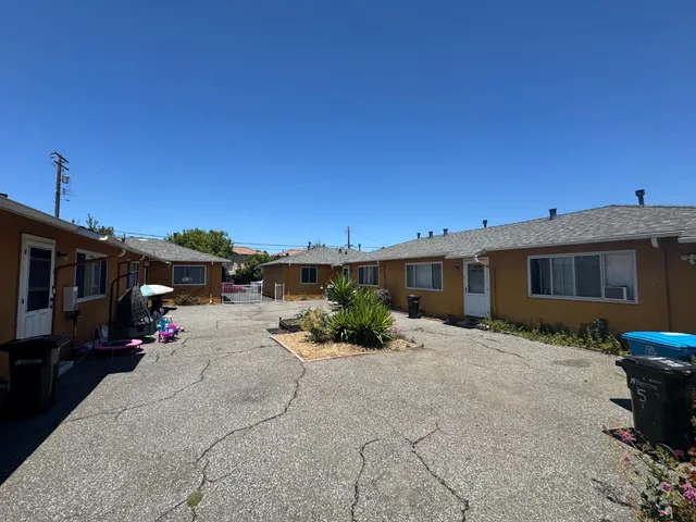 a row of car parked in front of a building
