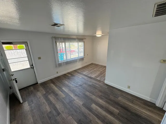 wooden floor in an empty room with a window