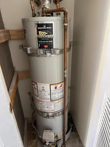 a room with water heater and racks on the wall