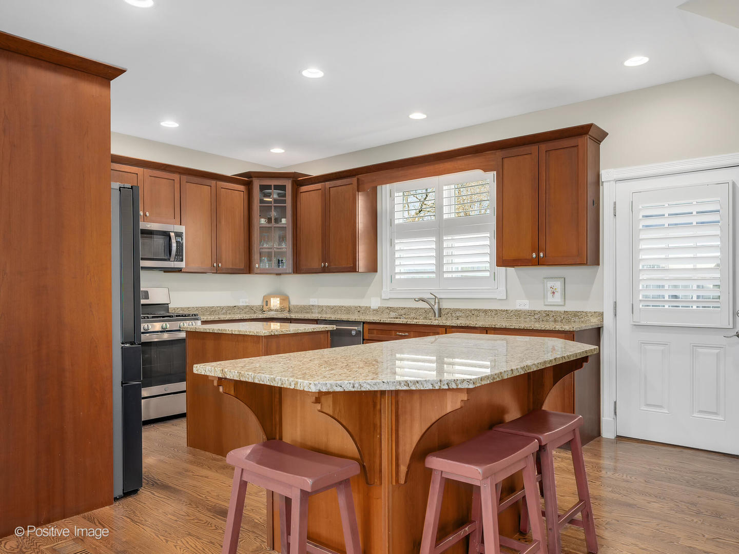 1607 East Indiana Street Wheaton, IL 60187 - Photo 11 of 31 a kitchen with granite countertop a stove a sink and a refrigerator