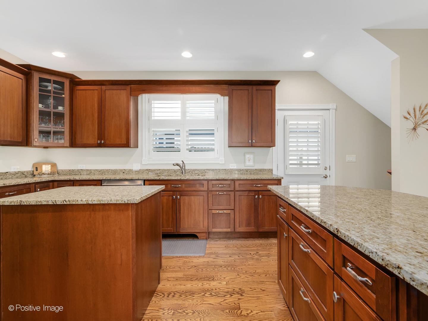 1607 East Indiana Street Wheaton, IL 60187 - Photo 12 of 31 a kitchen with stainless steel appliances granite countertop a sink stove and cabinets