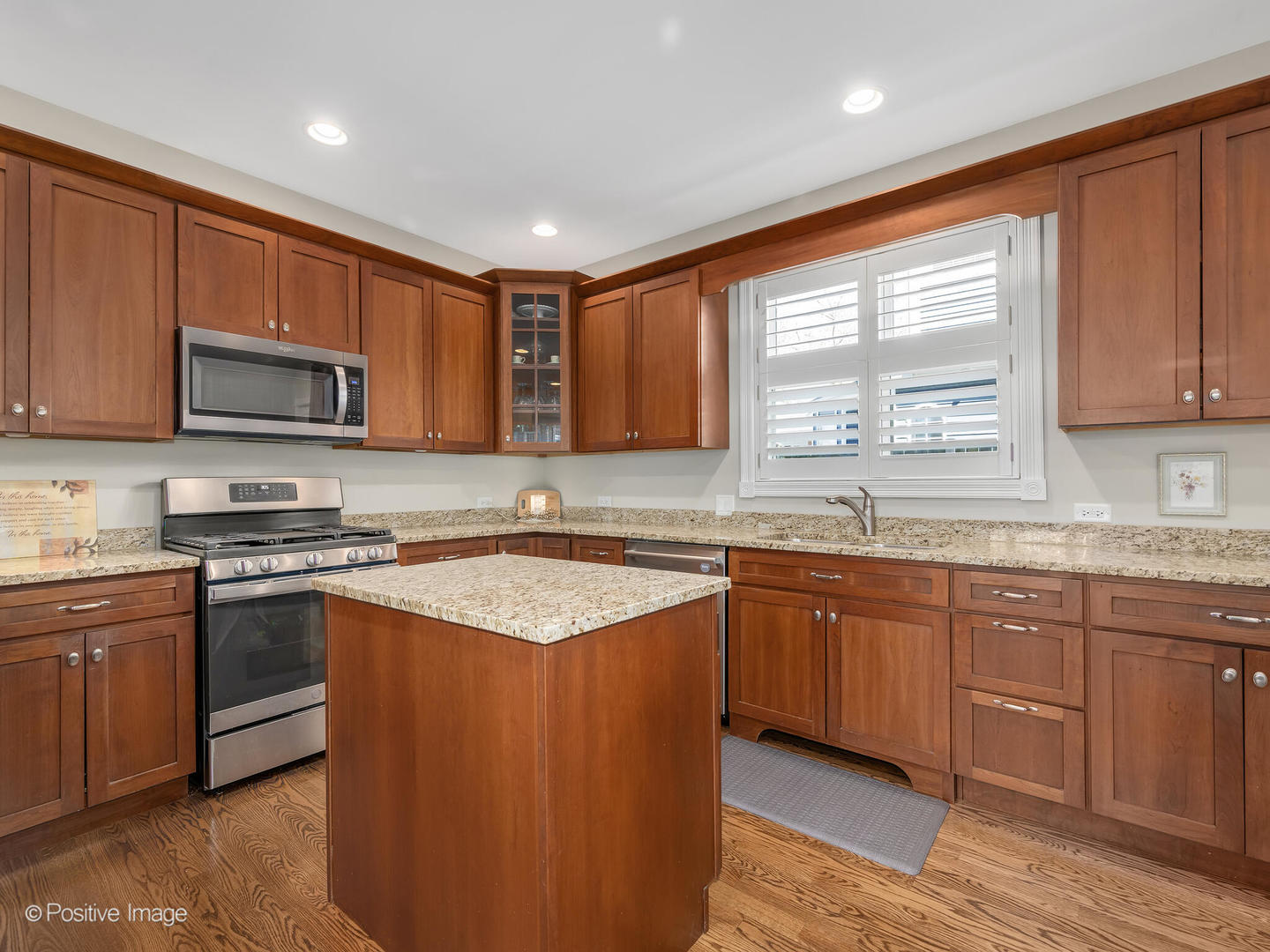 1607 East Indiana Street Wheaton, IL 60187 - Photo 13 of 31 a kitchen with stainless steel appliances granite countertop wooden cabinets a sink and a stove