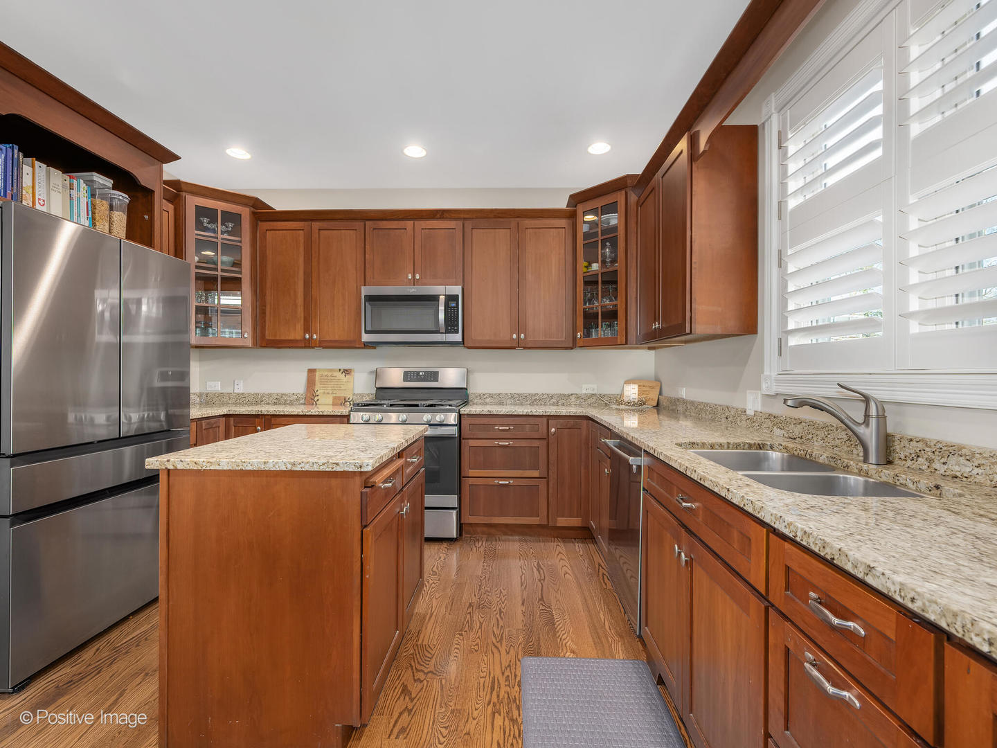 1607 East Indiana Street Wheaton, IL 60187 - Photo 14 of 31 a kitchen with stainless steel appliances granite countertop a sink stove and refrigerator