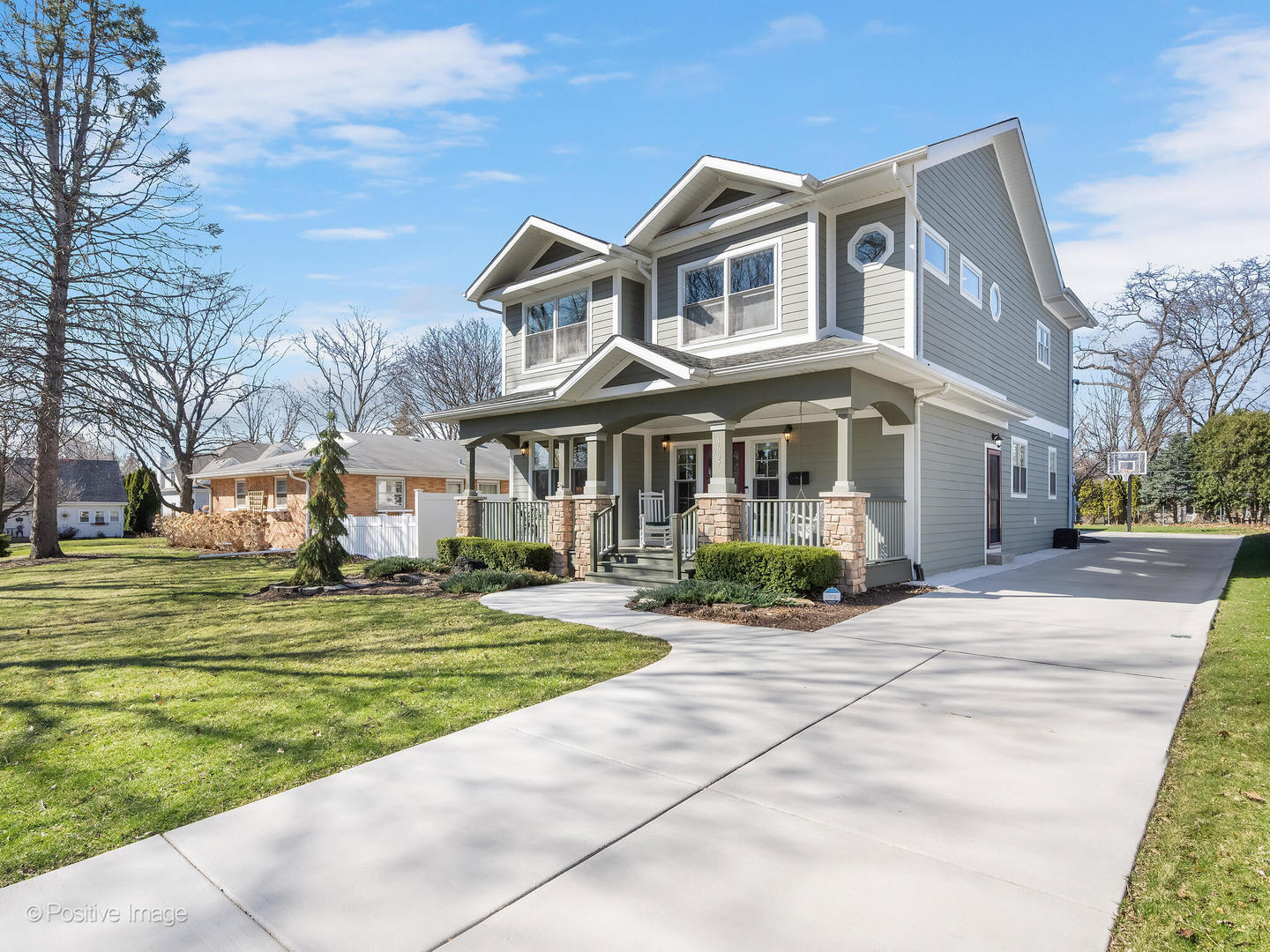 1607 East Indiana Street Wheaton, IL 60187 - Photo 2 of 31 a front view of a house with a garden and trees