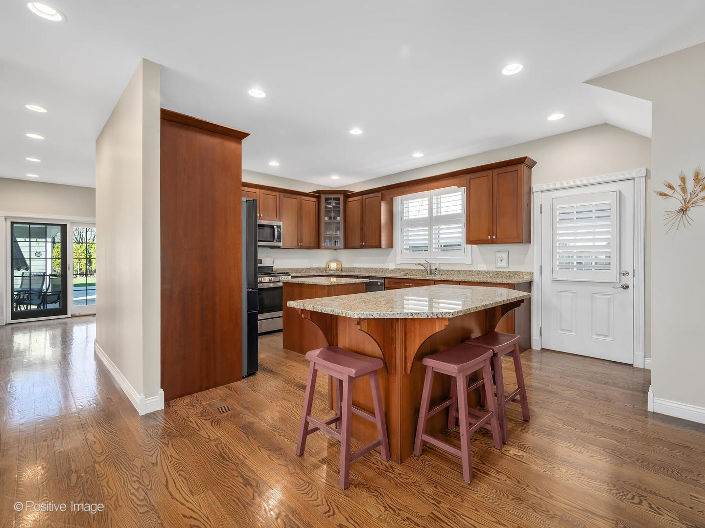 1607 East Indiana Street Wheaton, IL 60187 - Photo 10 of 31 a dining room with stainless steel appliances granite countertop a kitchen island a refrigerator and a view of living room