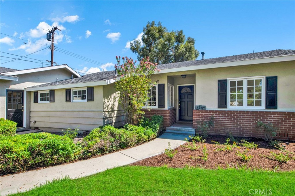 13172 Ethelbee Way North Tustin, CA 92705 - Photo 2 of 2 a front view of a house with a garden