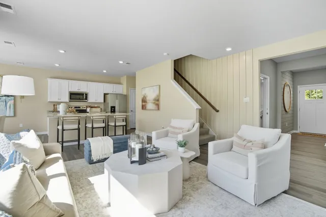 a living room with fireplace furniture and a wooden floor