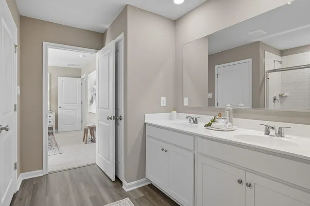 a en suite bathroom with a sink mirror and shower