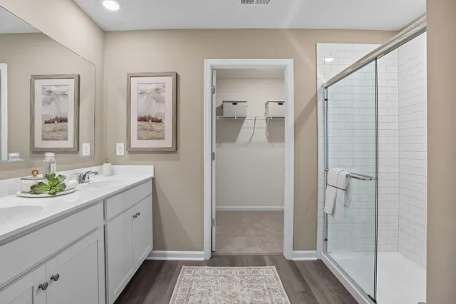 a bathroom with a sink a toilet a shower and a mirror