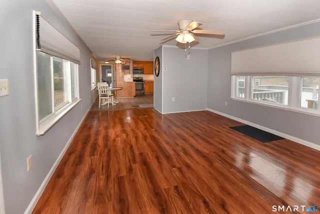 a view of a room with wooden floor and staircase