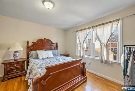 a bed sitting in a bedroom next to a window