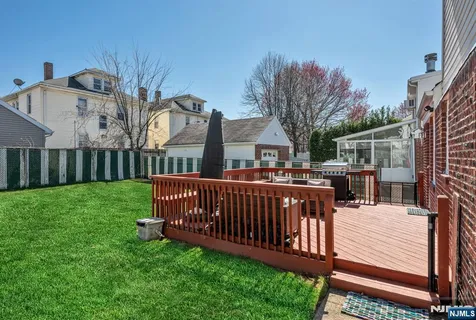 a view of a wooden deck and a yard