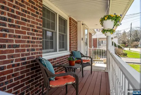 a balcony with wooden floor and outdoor seating
