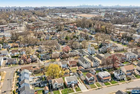 an aerial view of residential houses with city view