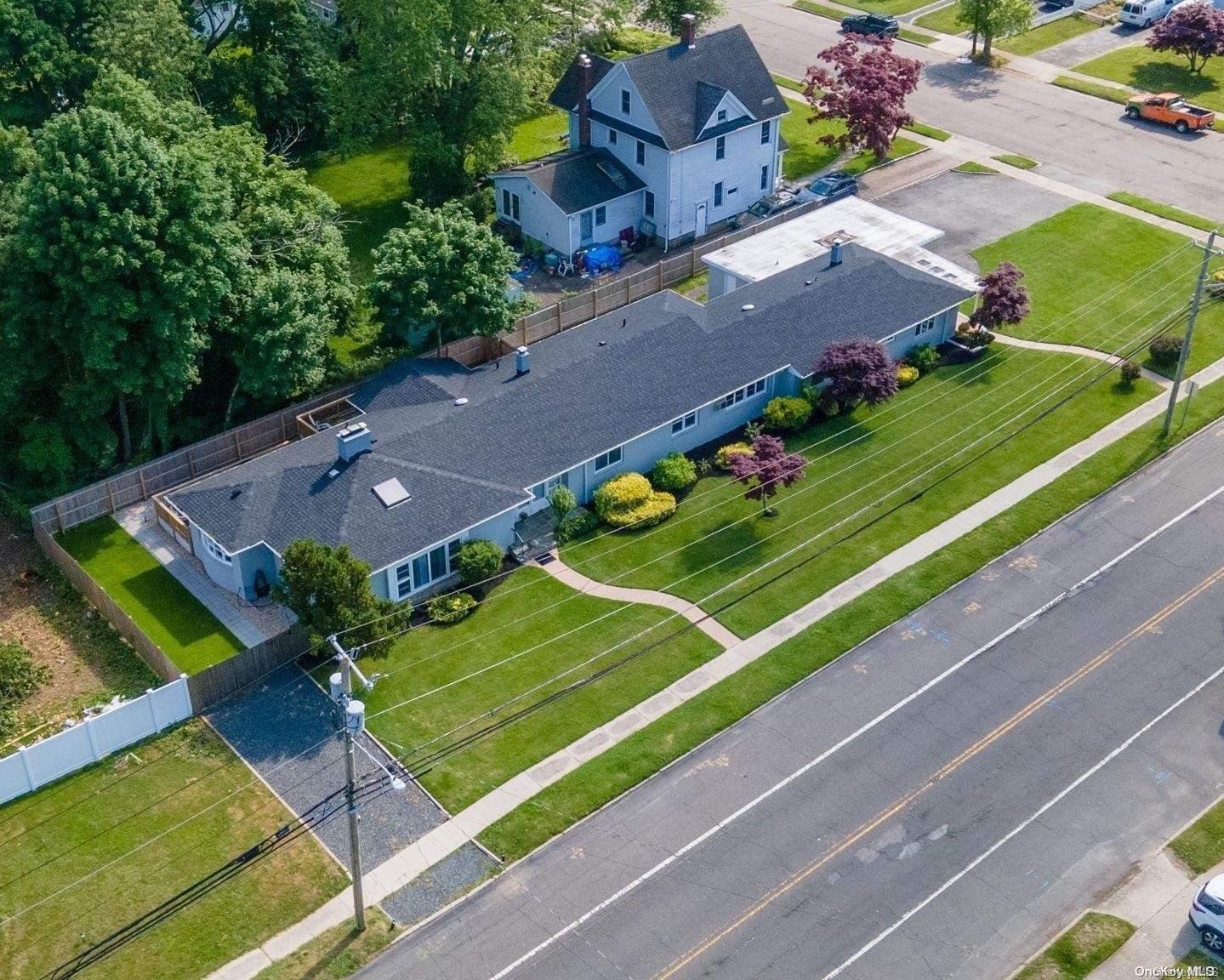 an aerial view of a tennis ground and a houses