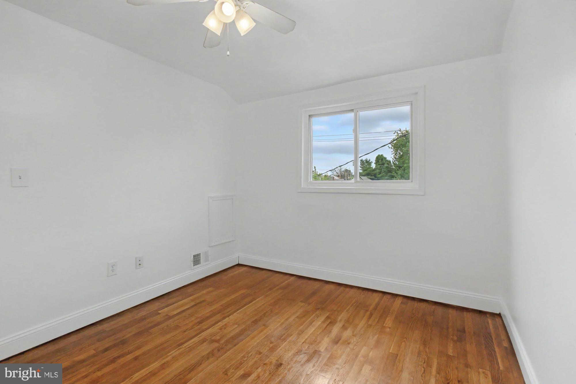 8218 Kavanagh Road Dundalk, MD 21222 - Photo 23 of 39 Bright and airy room with hardwood floors.