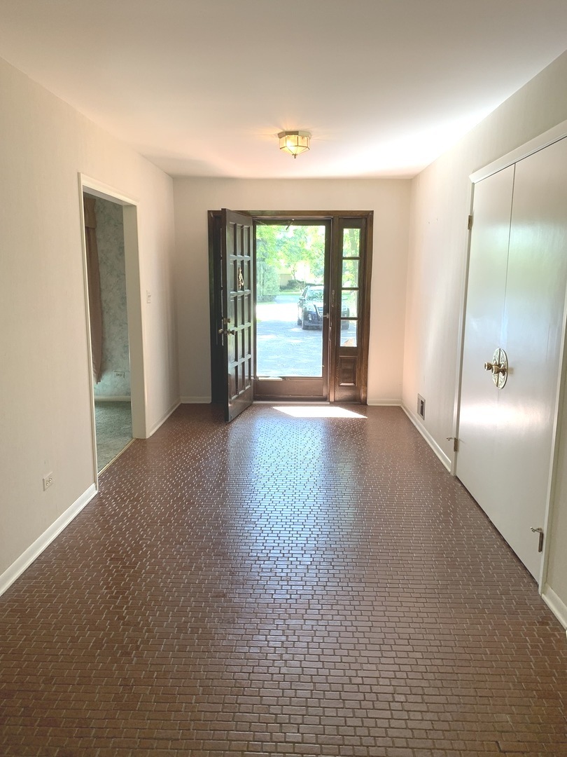 2210 Banbury Road Inverness, IL 60067 - Photo 2 of 41 a view of a big room with windows and chandelier fan