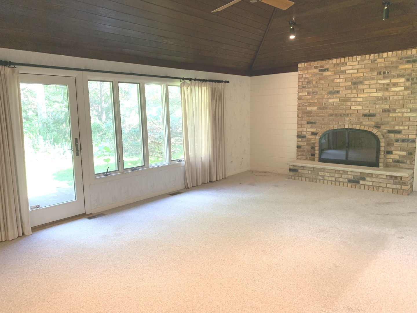 2210 Banbury Road Inverness, IL 60067 - Photo 16 of 41 a view of an empty room with a fireplace and a window