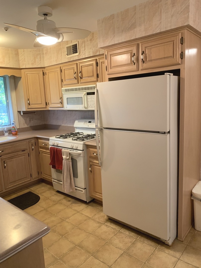 2210 Banbury Road Inverness, IL 60067 - Photo 4 of 41 a white refrigerator freezer and a stove sitting inside of a kitchen
