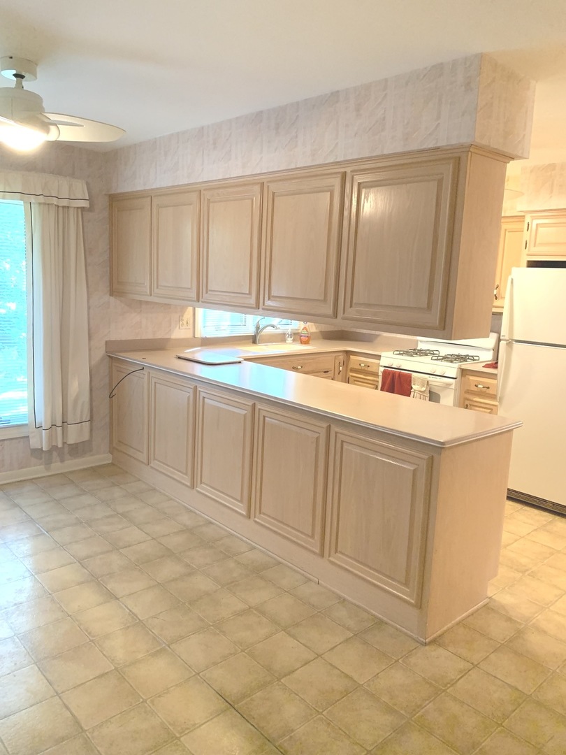 2210 Banbury Road Inverness, IL 60067 - Photo 6 of 41 a kitchen with stainless steel appliances granite countertop a stove a sink and a refrigerator