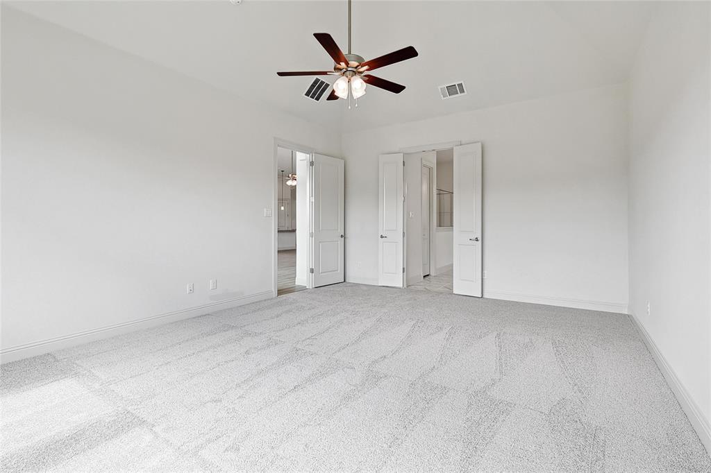 521 Carriage Hl Road Midlothian, TX 76065 - Photo 11 of 26 Unfurnished bedroom featuring light colored carpet, a ceiling fan, and ensuite bath