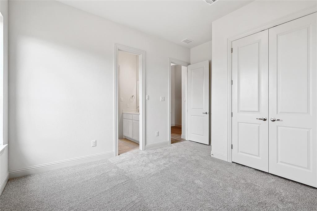 521 Carriage Hl Road Midlothian, TX 76065 - Photo 17 of 26 Unfurnished bedroom with light colored carpet, ensuite bathroom, and a closet