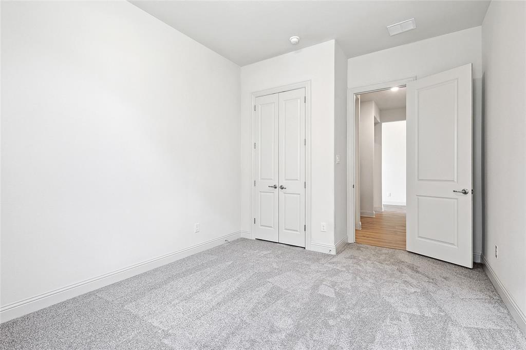 521 Carriage Hl Road Midlothian, TX 76065 - Photo 18 of 26 Unfurnished bedroom with light carpet and a closet