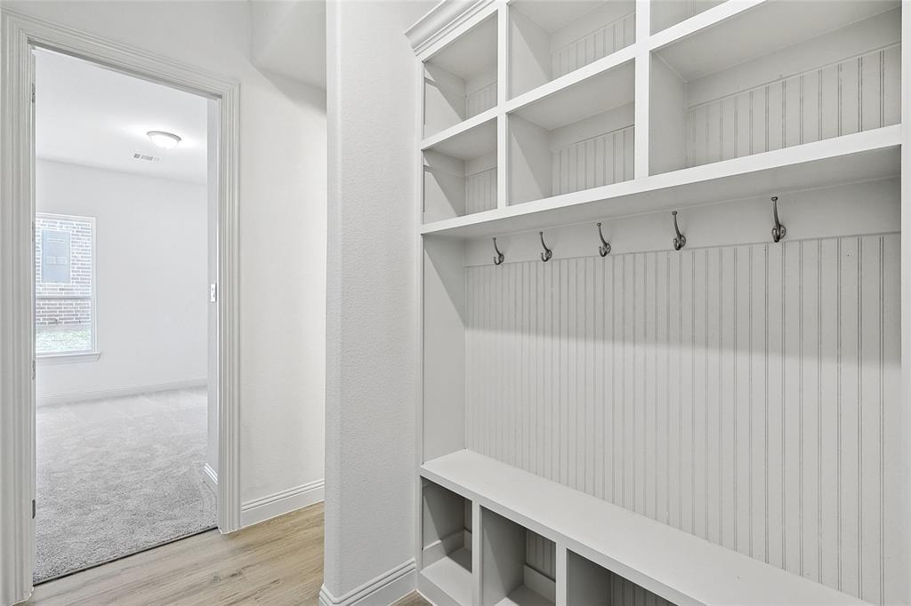 521 Carriage Hl Road Midlothian, TX 76065 - Photo 23 of 26 Mudroom featuring light wood-style flooring and baseboards