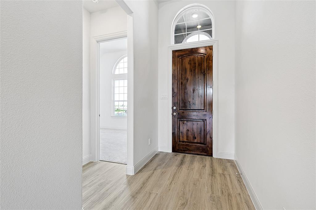 521 Carriage Hl Road Midlothian, TX 76065 - Photo 3 of 26 Entryway with light wood finished floors and a textured wall