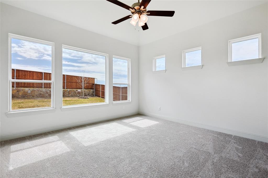 521 Carriage Hl Road Midlothian, TX 76065 - Photo 8 of 26 Unfurnished room featuring light carpet, healthy amount of natural light, and a ceiling fan