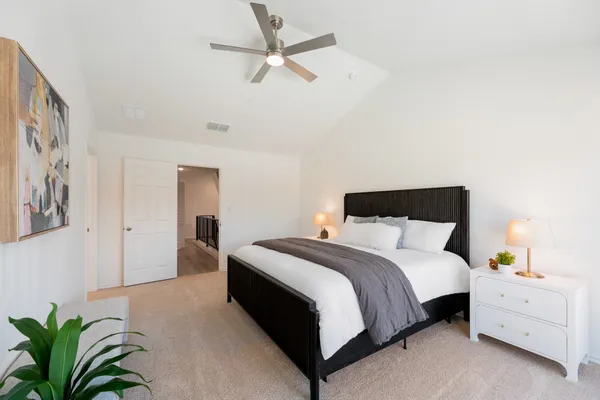 a bedroom with a bed and a potted plant