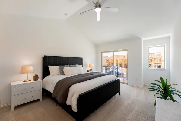 a bed room with a bed and a potted plant
