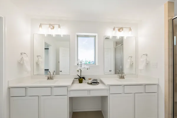 a bathroom with double sink and a mirror