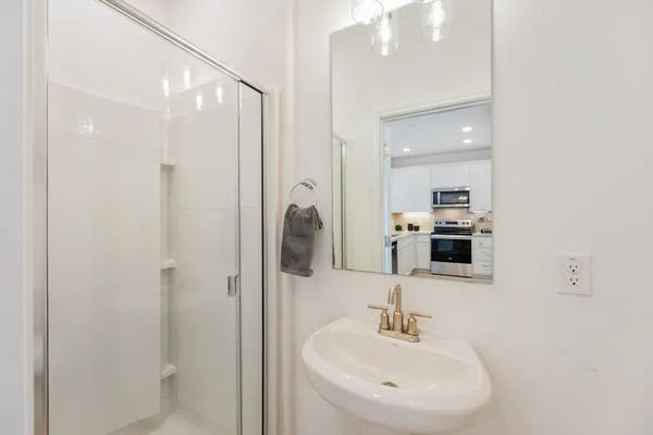 a bathroom with a sink a vanity and a mirror