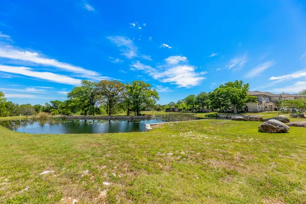 a view of swimming pool with a backyard and a tree