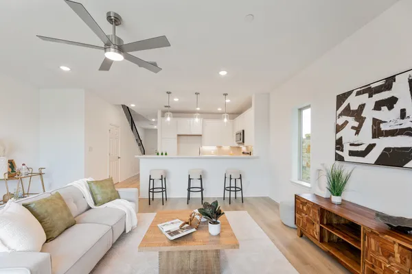 a living room with furniture and a wooden floor