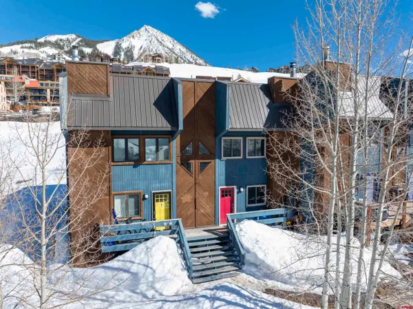 a view of a house with a yard covered in snow