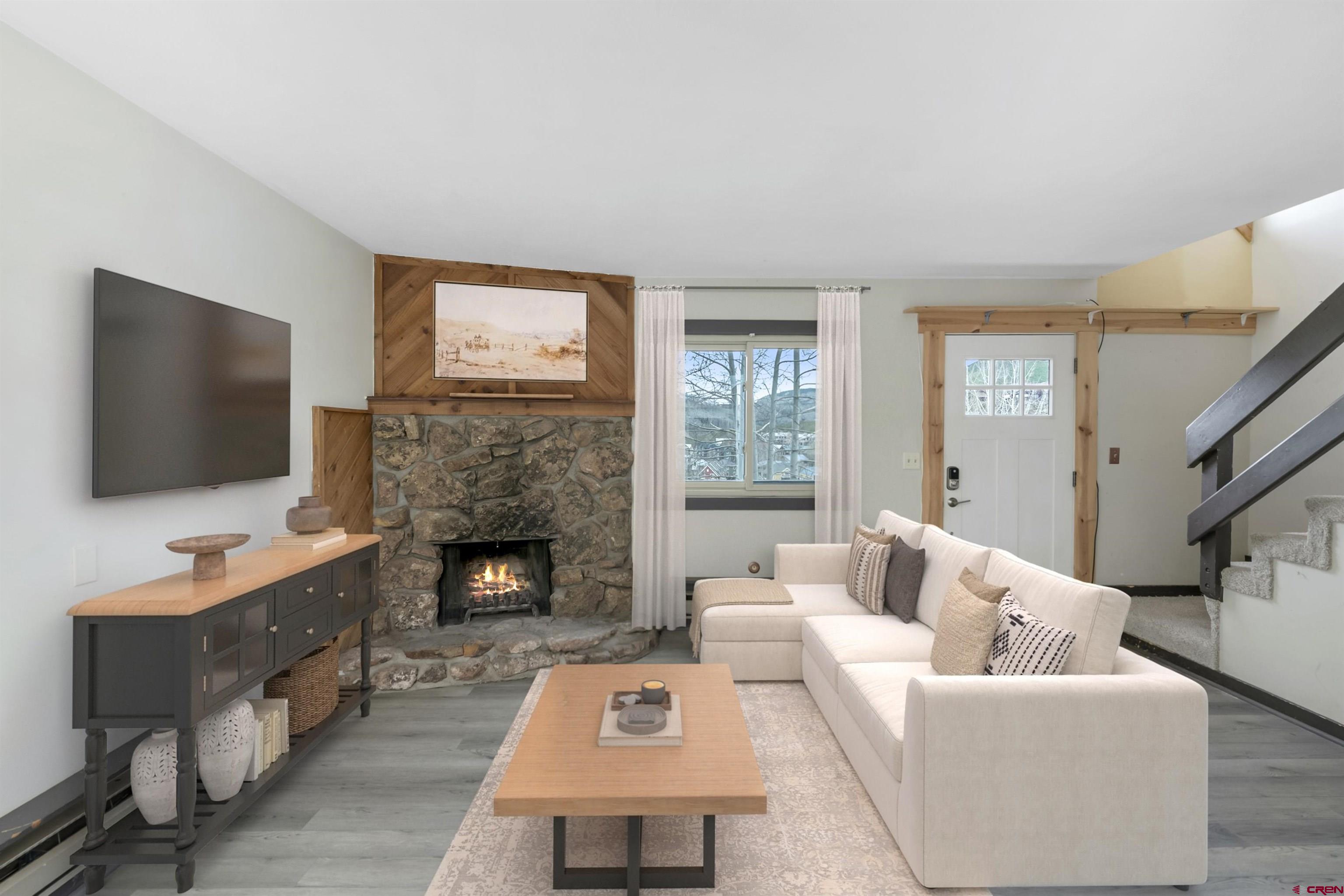 22 Castle Road, Unit 2 Crested Butte, CO 81225 - Photo 14 of 38 a living room with furniture a flat screen tv and a fireplace