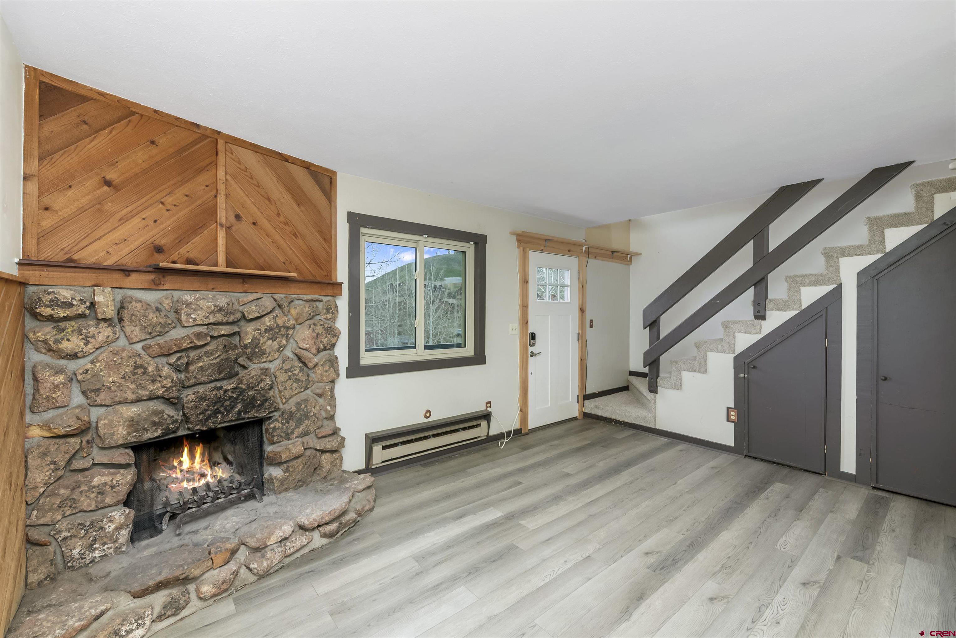 22 Castle Road, Unit 2 Crested Butte, CO 81225 - Photo 15 of 38 a view of an empty room with wooden floor and a fireplace