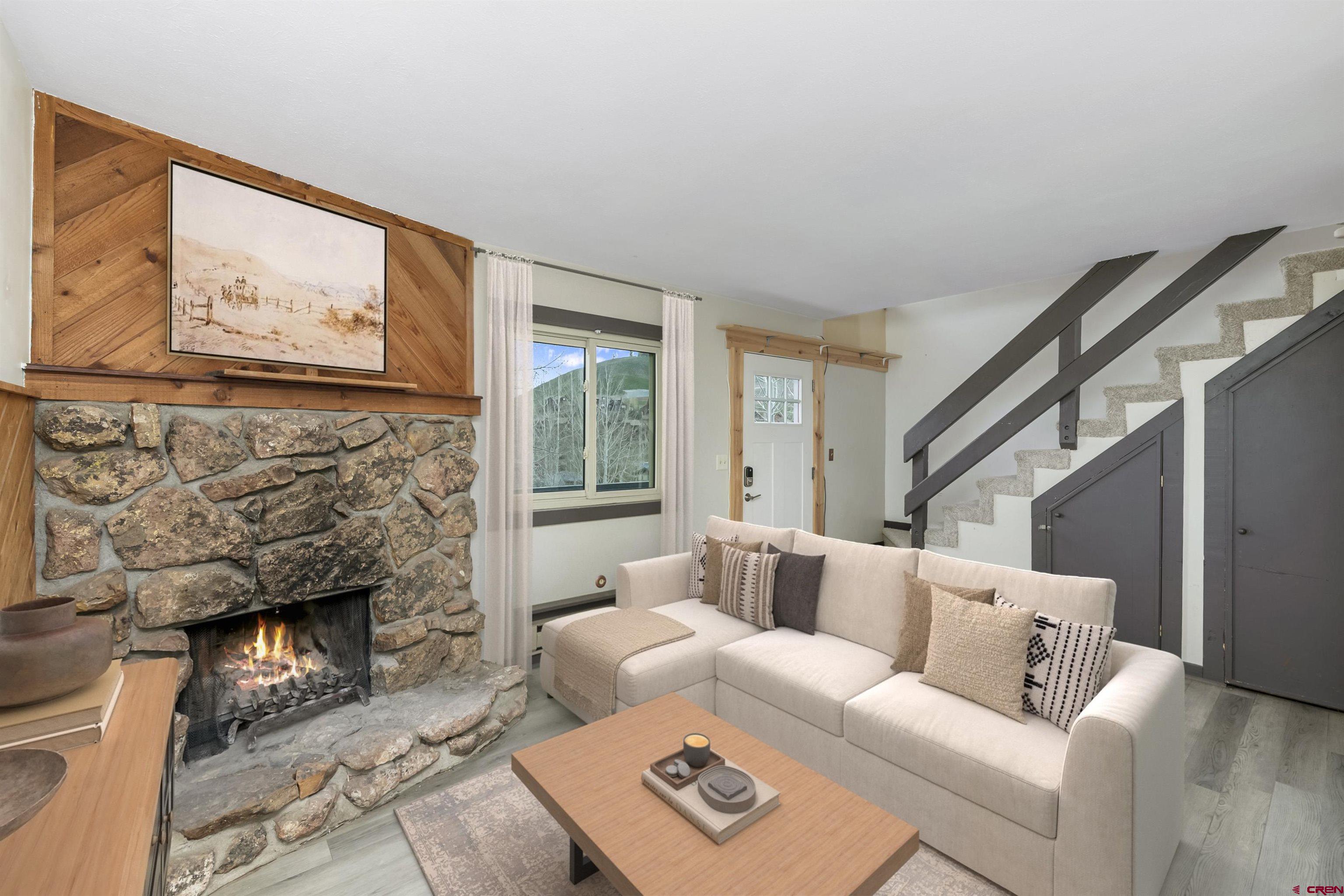 22 Castle Road, Unit 2 Crested Butte, CO 81225 - Photo 16 of 38 a living room with furniture and a fireplace
