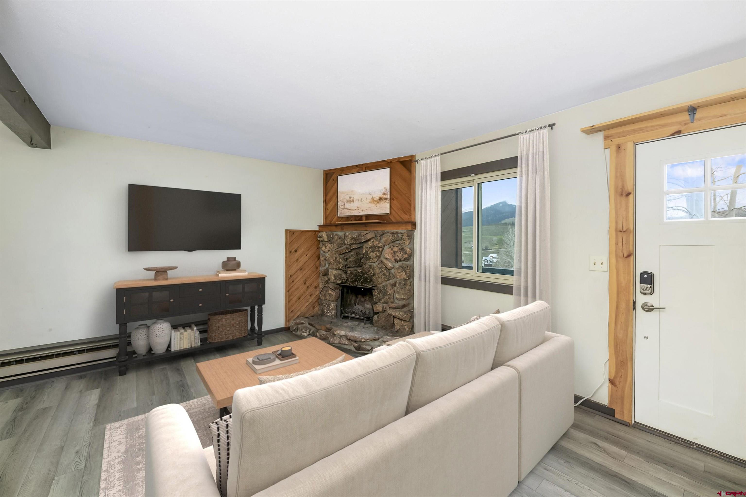 22 Castle Road, Unit 2 Crested Butte, CO 81225 - Photo 18 of 38 a living room with furniture and a flat screen tv