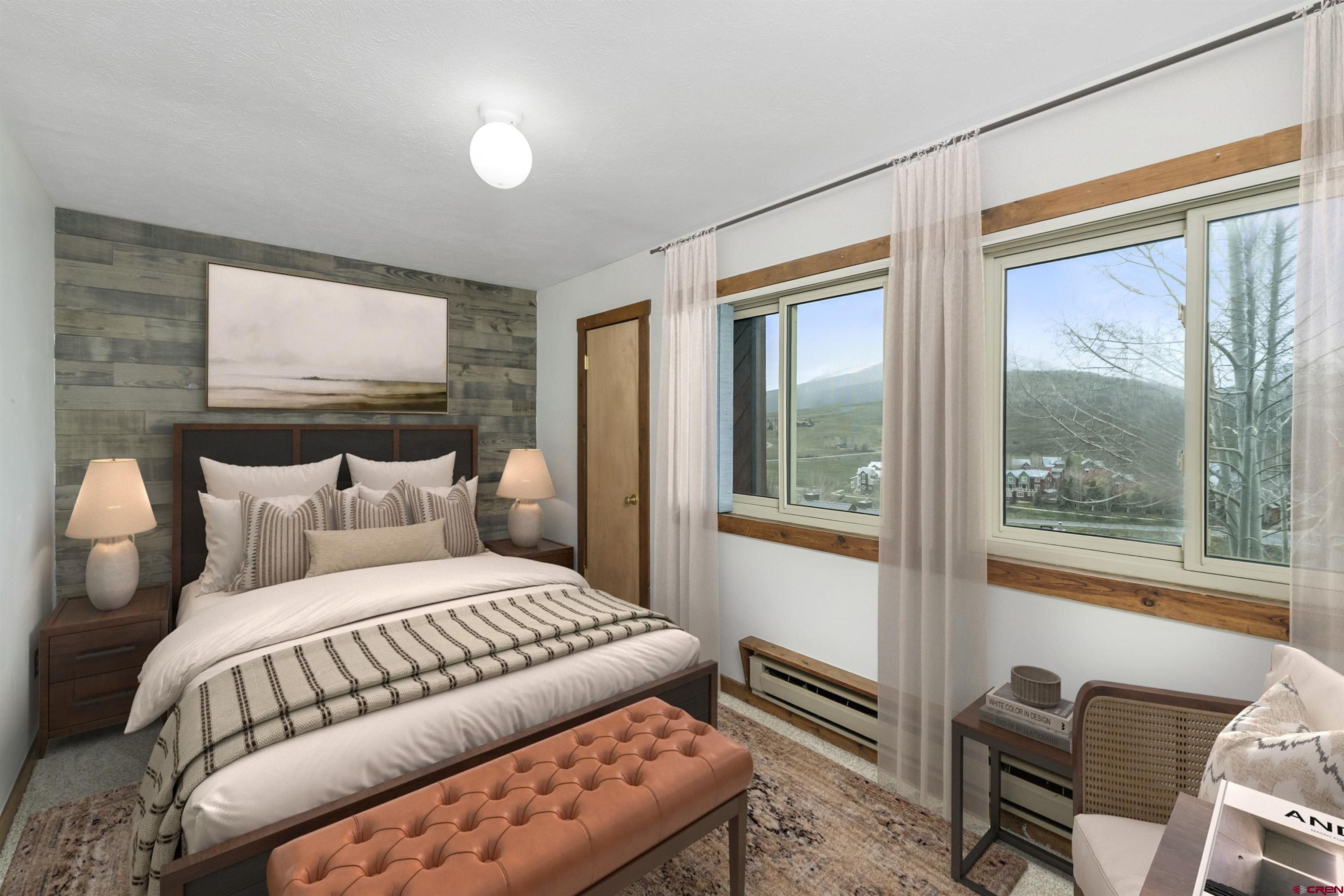 22 Castle Road, Unit 2 Crested Butte, CO 81225 - Photo 19 of 34 a bedroom with a bed and glass window