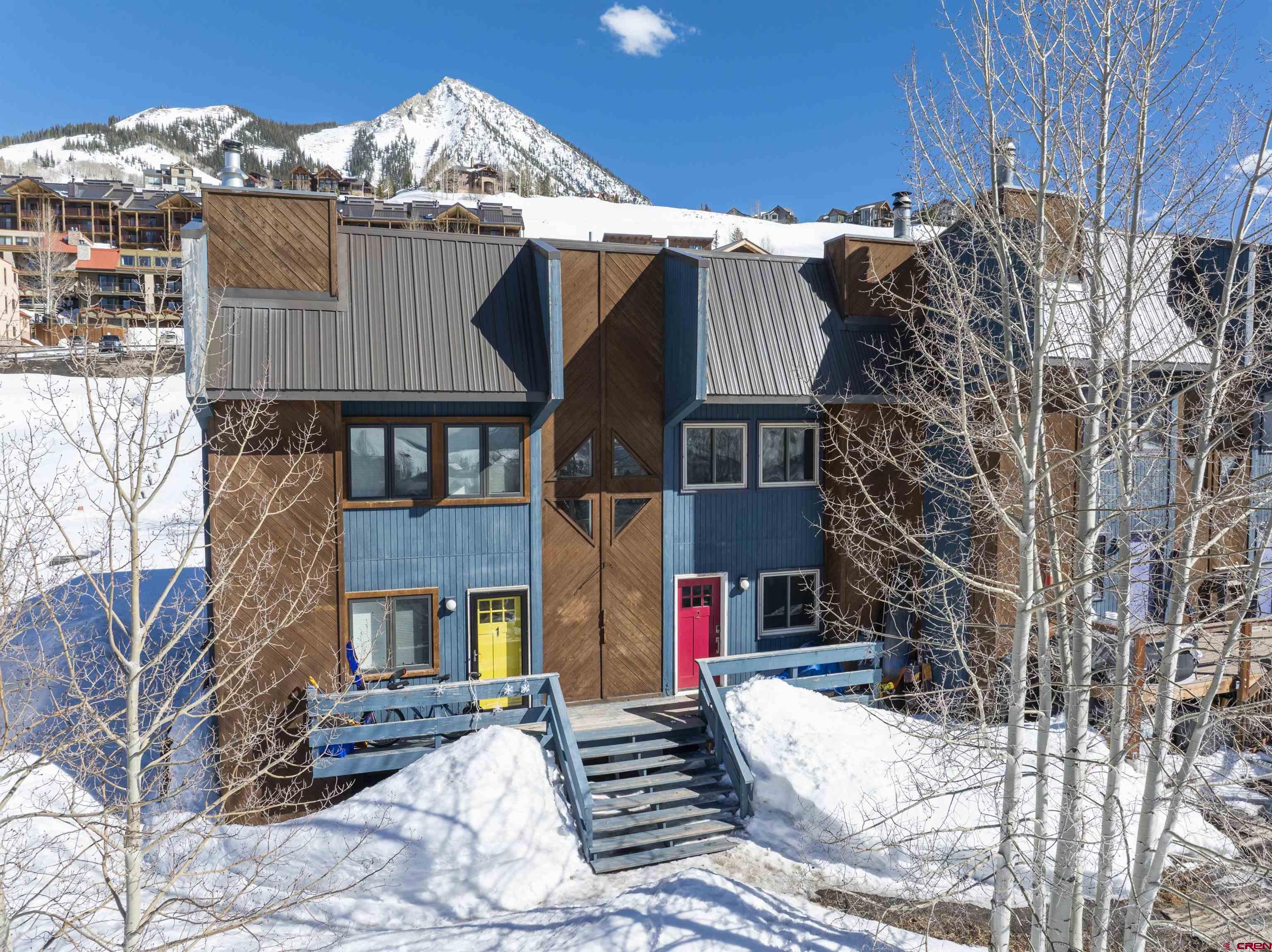 22 Castle Road, Unit 2 Crested Butte, CO 81225 - Photo 2 of 38 a view of a house with a yard covered in snow