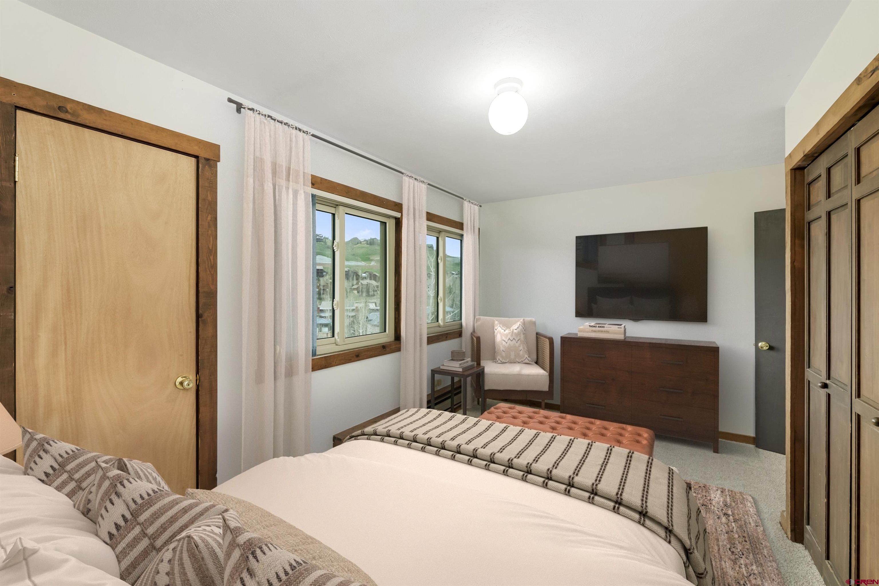 22 Castle Road, Unit 2 Crested Butte, CO 81225 - Photo 21 of 34 a bedroom with a bed and a flat screen tv