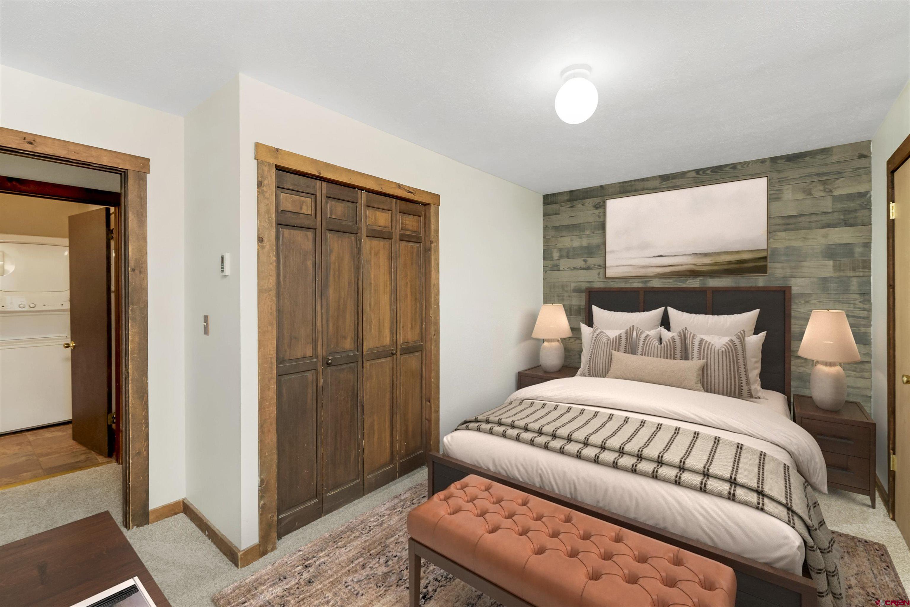 22 Castle Road, Unit 2 Crested Butte, CO 81225 - Photo 23 of 34 a bedroom with a bed and a mirror